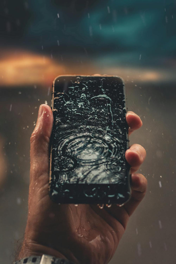 water splashing on the screen of smartphone