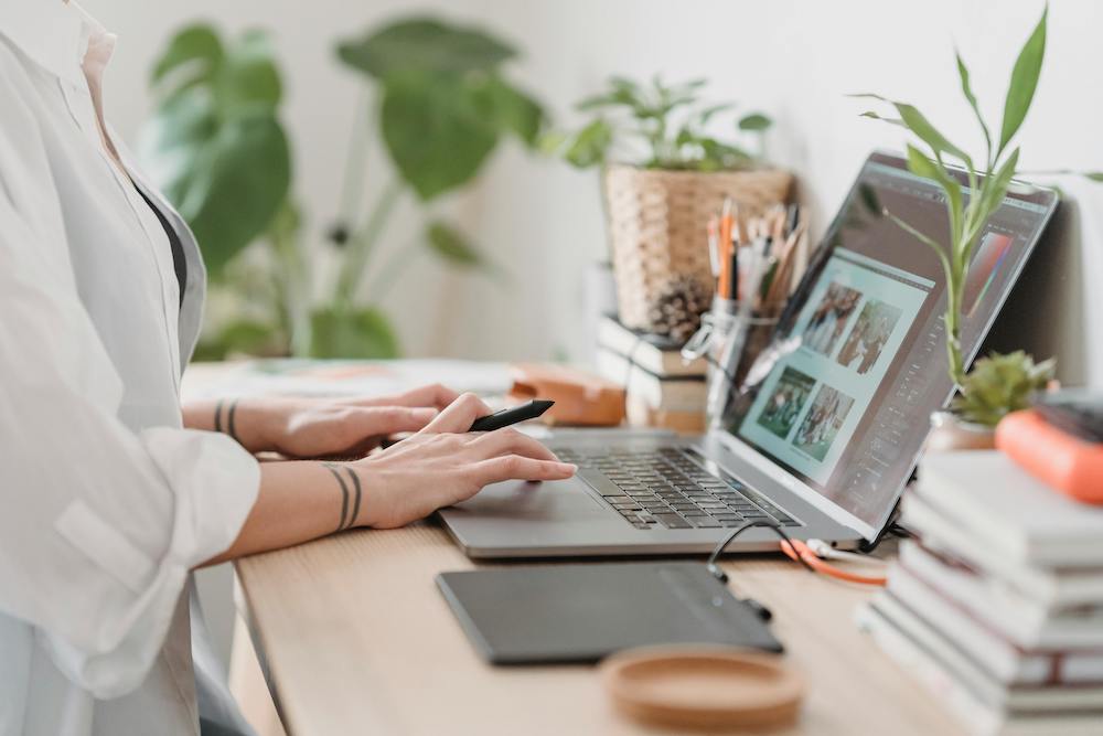 worker at desk surrounded by plants